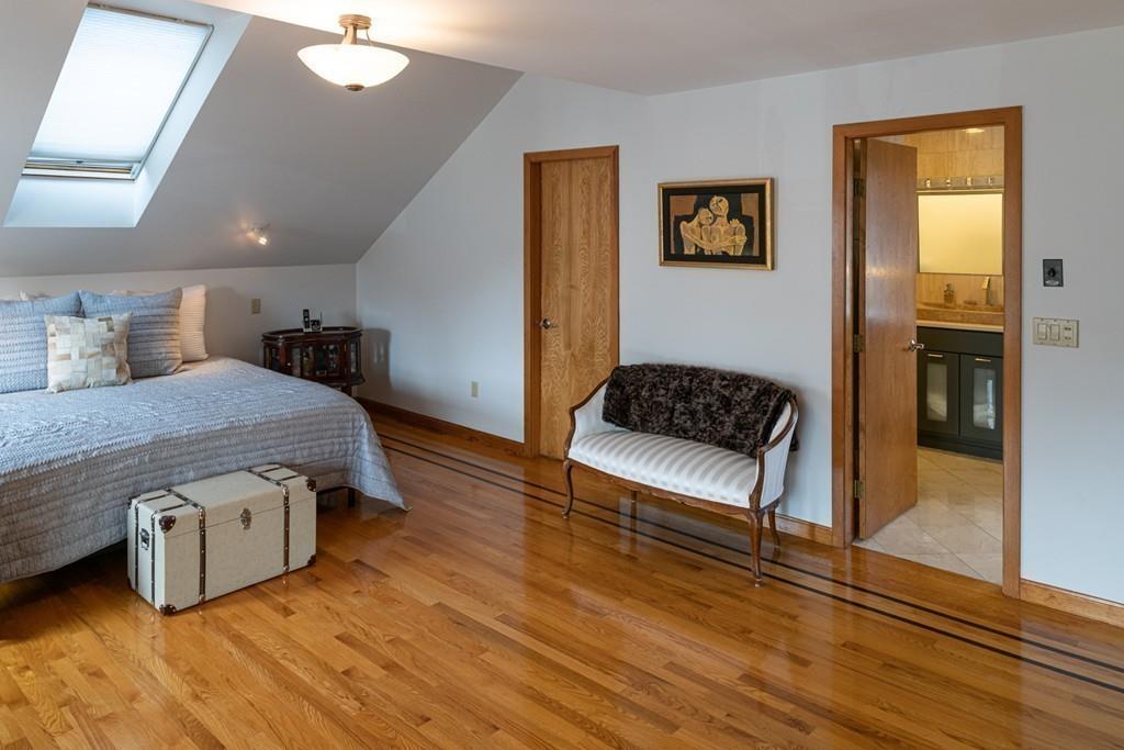 13 McKinley Road Marblehead, MA 01945 - Photo 16 of 36 a spacious bedroom with a bed and a table