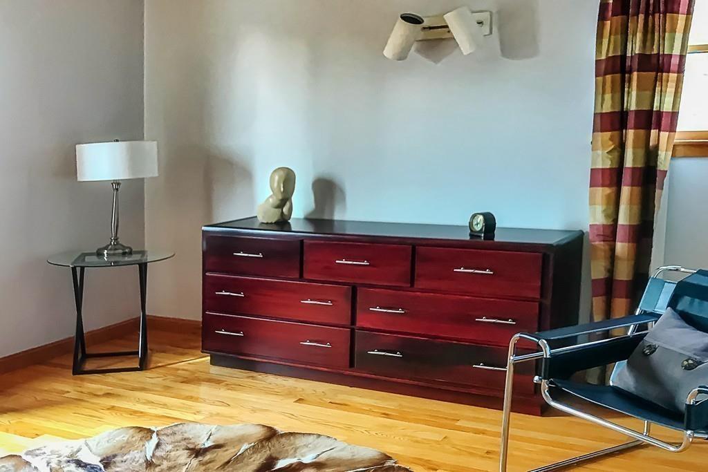 13 McKinley Road Marblehead, MA 01945 - Photo 22 of 36 a room with a bed and a lamp on the dresser