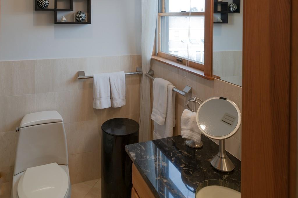 13 McKinley Road Marblehead, MA 01945 - Photo 24 of 36 a bathroom with a toilet mirror and vanity