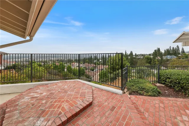 an aerial view of house with yard and mountain view in back