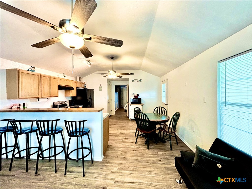 101 13th Street Seadrift, TX 77983 - Photo 13 of 42 a view of a dining room and livingroom with furniture wooden floor and a chandelier