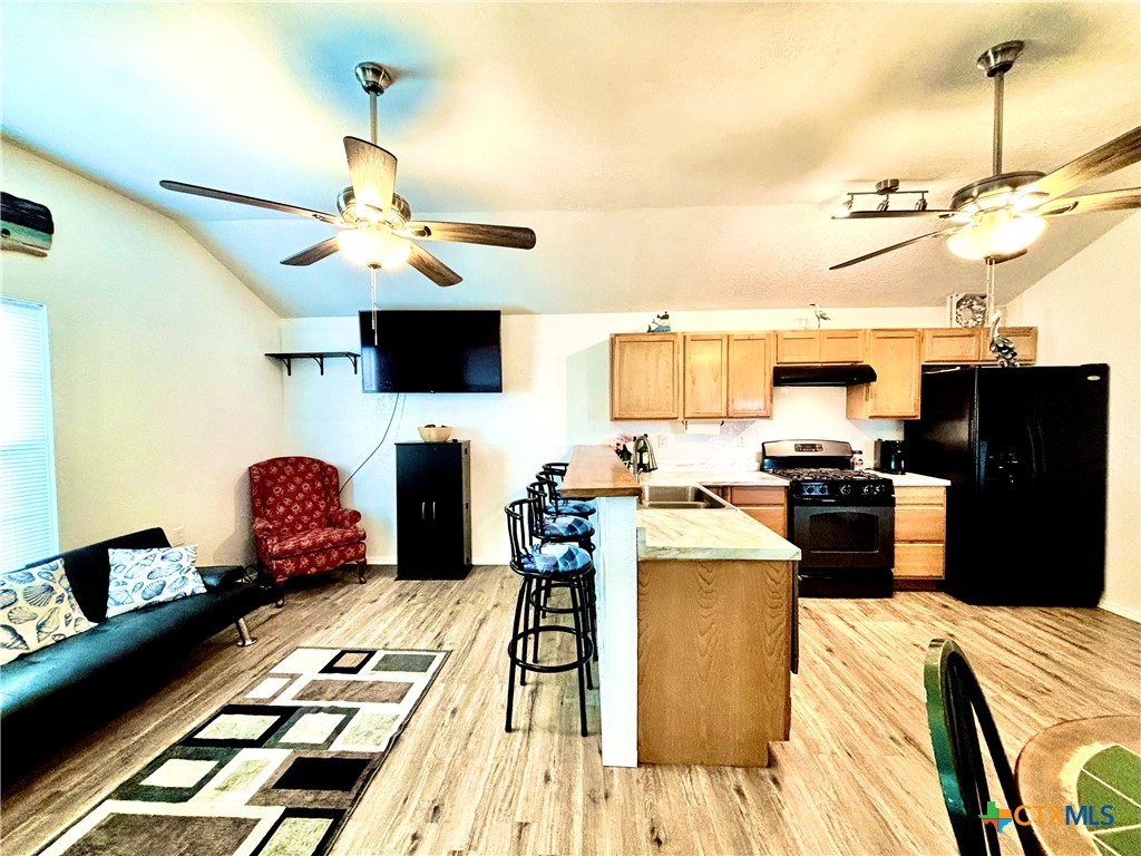 101 13th Street Seadrift, TX 77983 - Photo 16 of 42 a kitchen with a refrigerator and a stove top oven