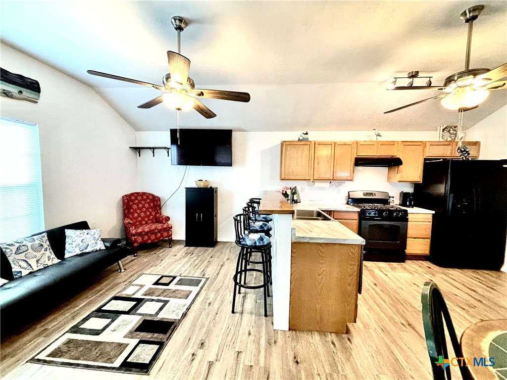 101 13th Street Seadrift, TX 77983 - Photo 25 of 42 a kitchen with a table chairs and a stove