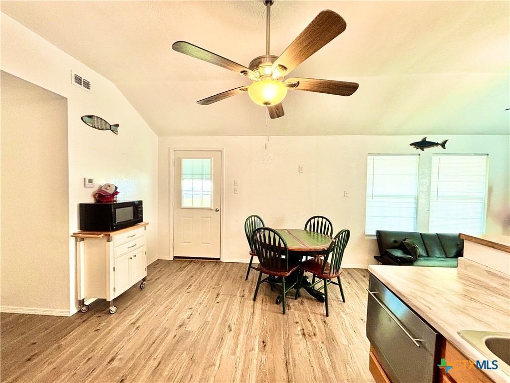 101 13th Street Seadrift, TX 77983 - Photo 28 of 42 a view of a dining room with furniture and a chandelier