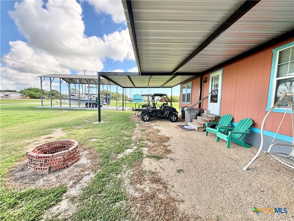 101 13th Street Seadrift, TX 77983 - Photo 7 of 42 a view of a backyard with table and chairs under an umbrella