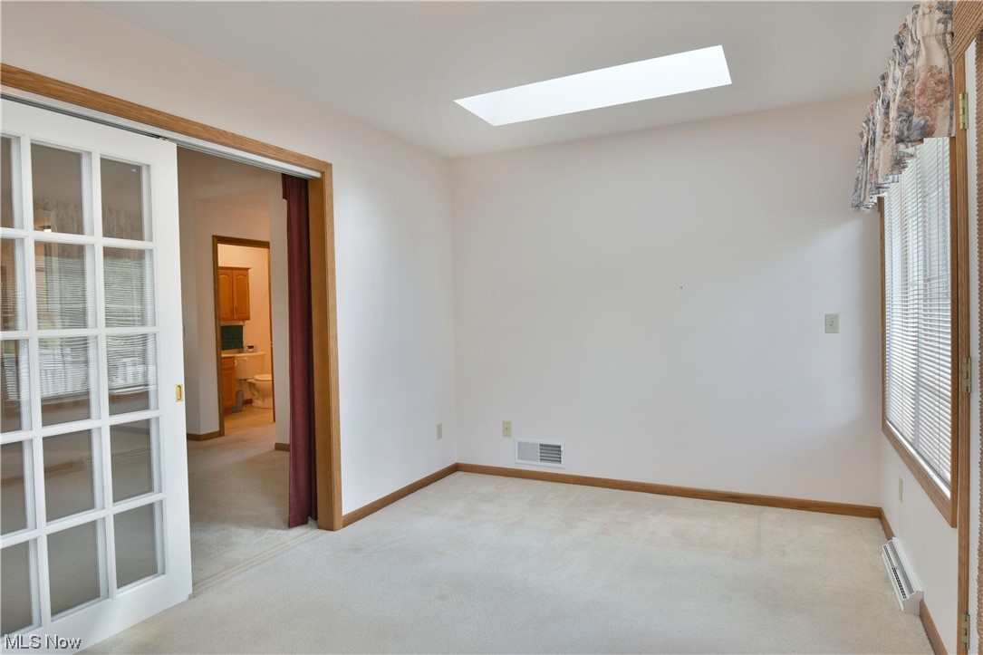 2033 East River Road, Unit 11 Newton Falls, OH 44444 - Photo 17 of 35 Unfurnished room with baseboard heating and light carpet