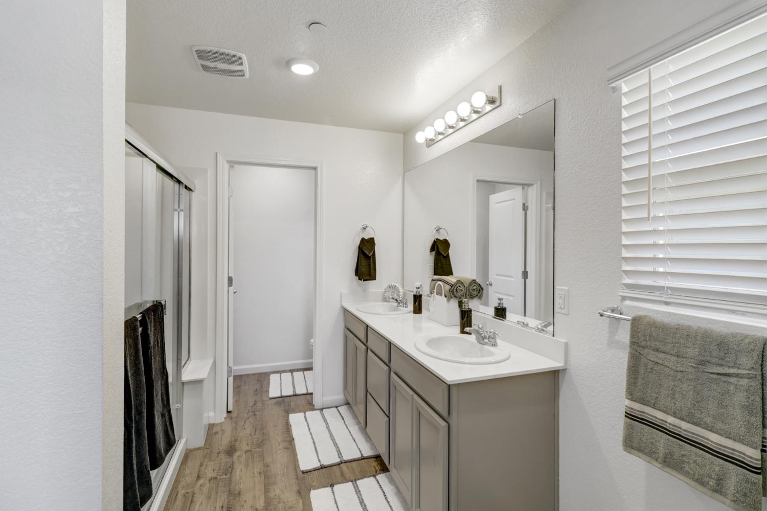 2887 Krone Way Antelope, CA 95843 - Photo 22 of 46 a bathroom with a double vanity sink a and mirror