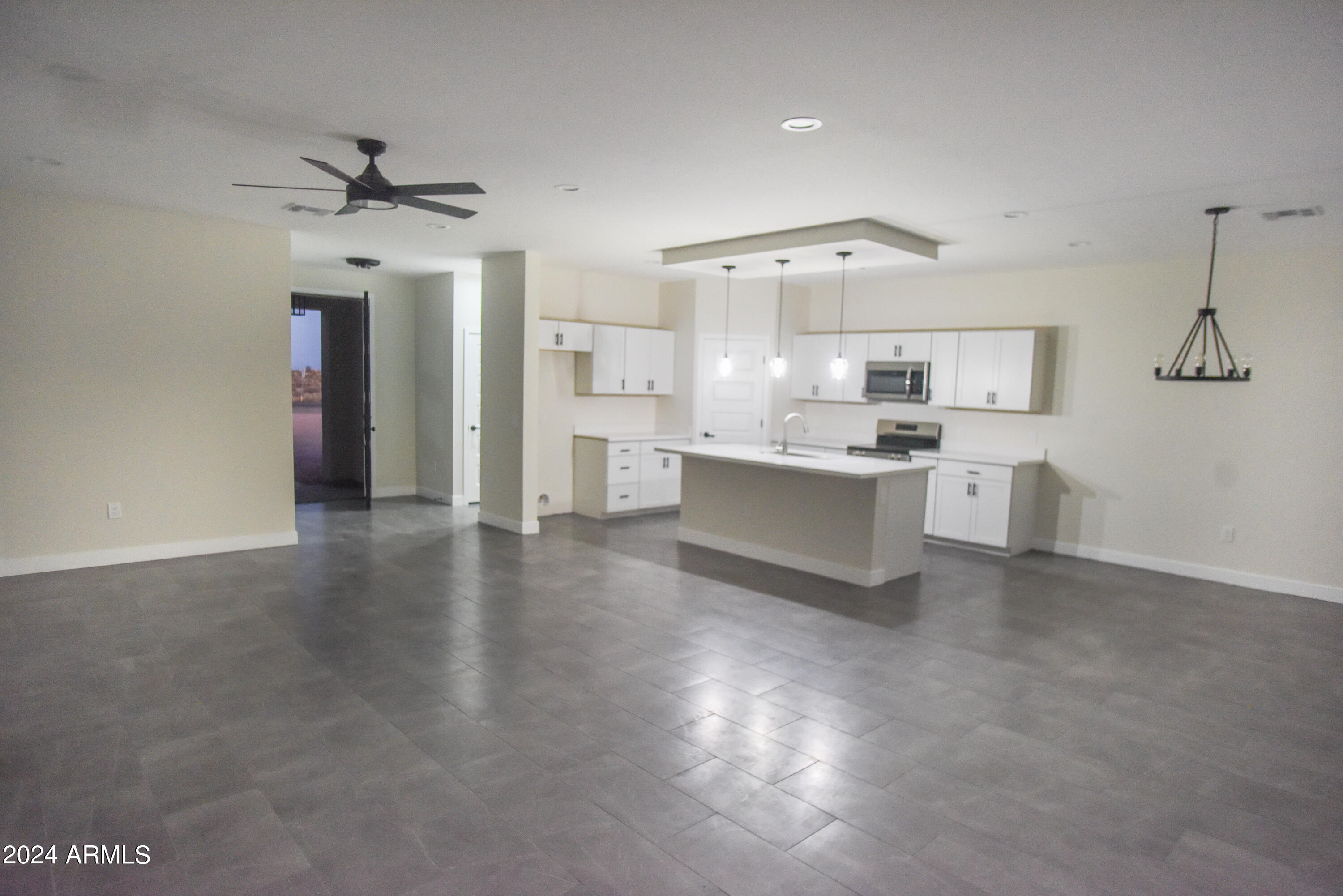 1028 South Wintersburg Road Tonopah, AZ 85354 - Photo 16 of 48 a view of a kitchen with a sink cabinets and wooden floor