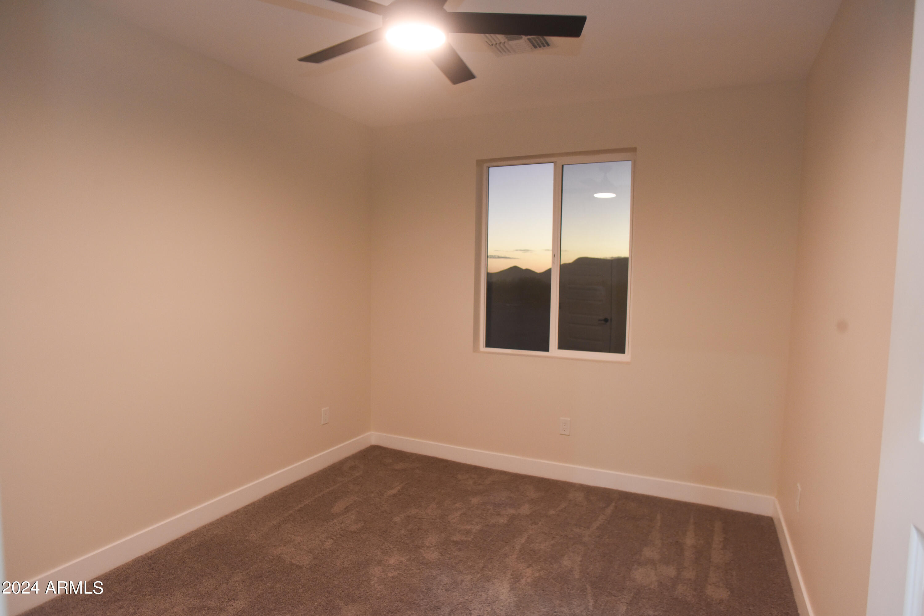 1028 South Wintersburg Road Tonopah, AZ 85354 - Photo 22 of 48 a view of an empty room with a window
