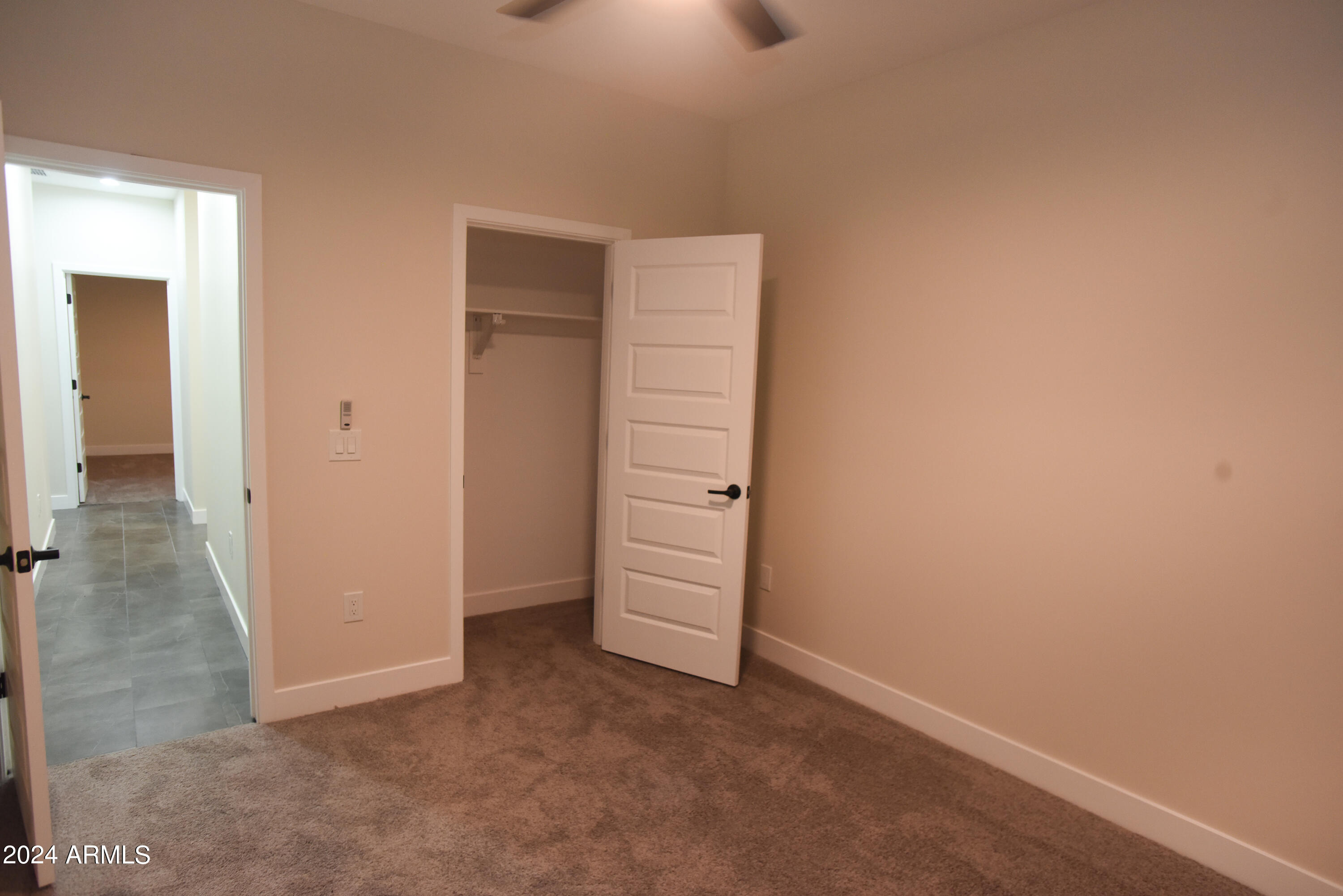 1028 South Wintersburg Road Tonopah, AZ 85354 - Photo 23 of 48 an empty room with a hallway and closet