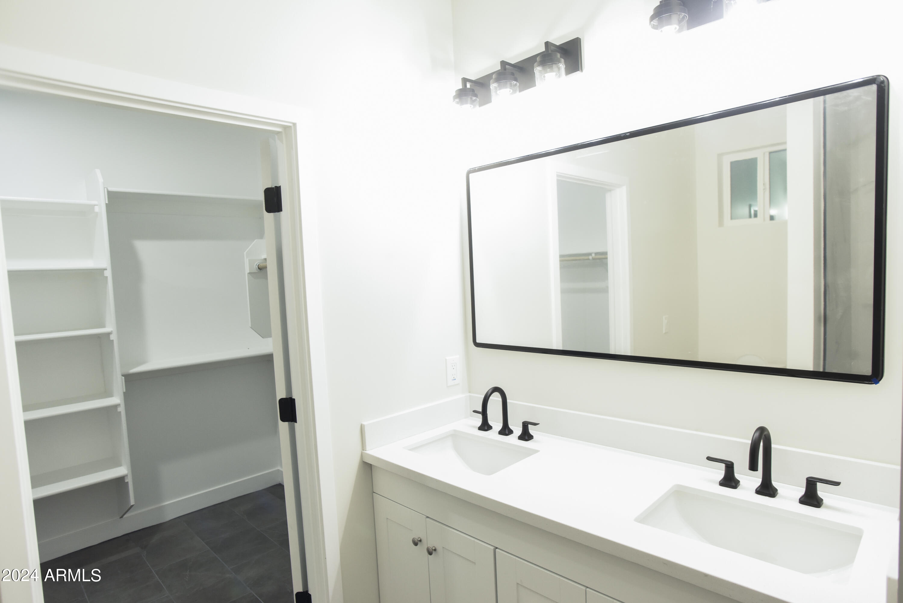 1028 South Wintersburg Road Tonopah, AZ 85354 - Photo 27 of 48 a bathroom with a sink and a mirror