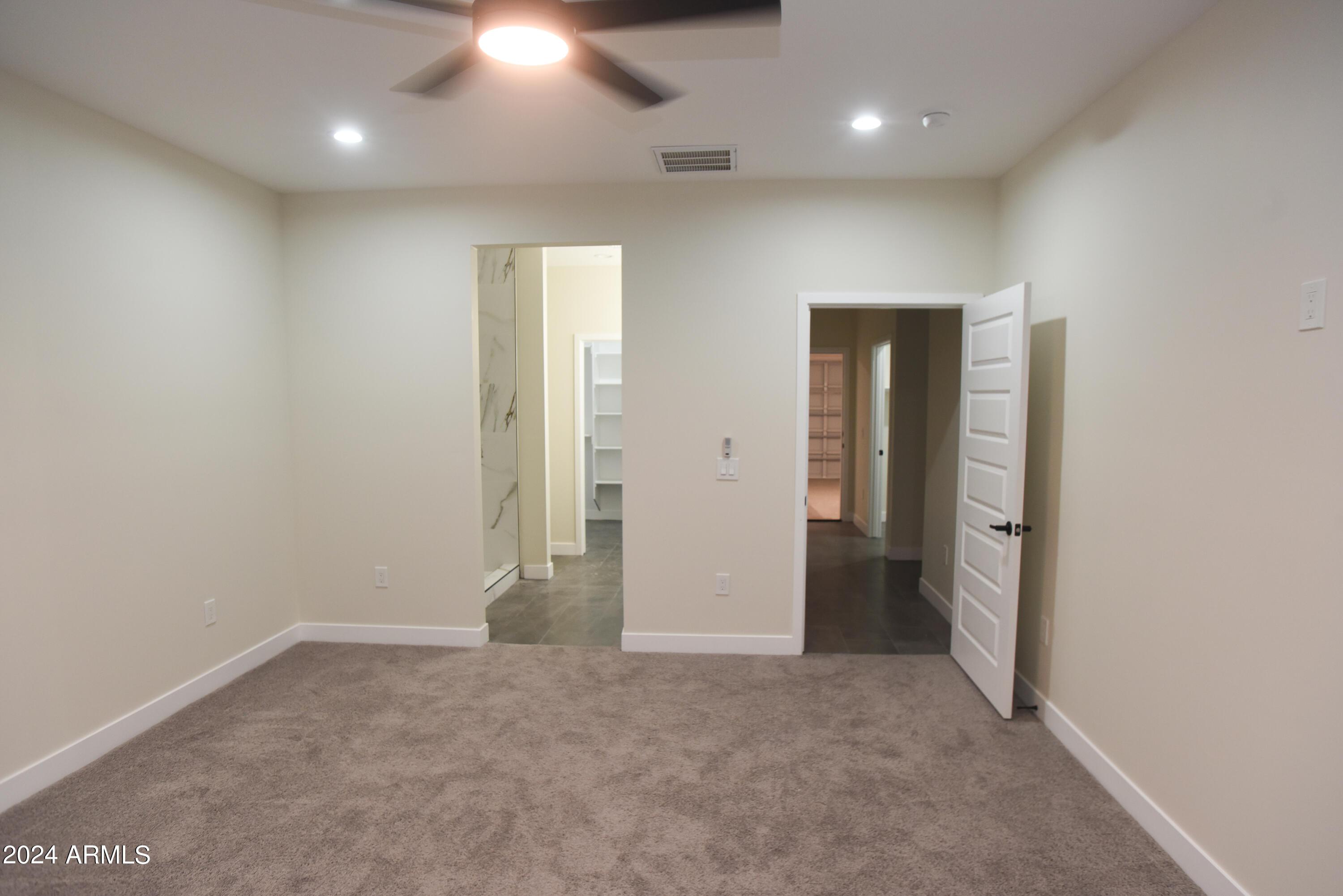 1028 South Wintersburg Road Tonopah, AZ 85354 - Photo 29 of 48 an empty room with closet and wooden floor