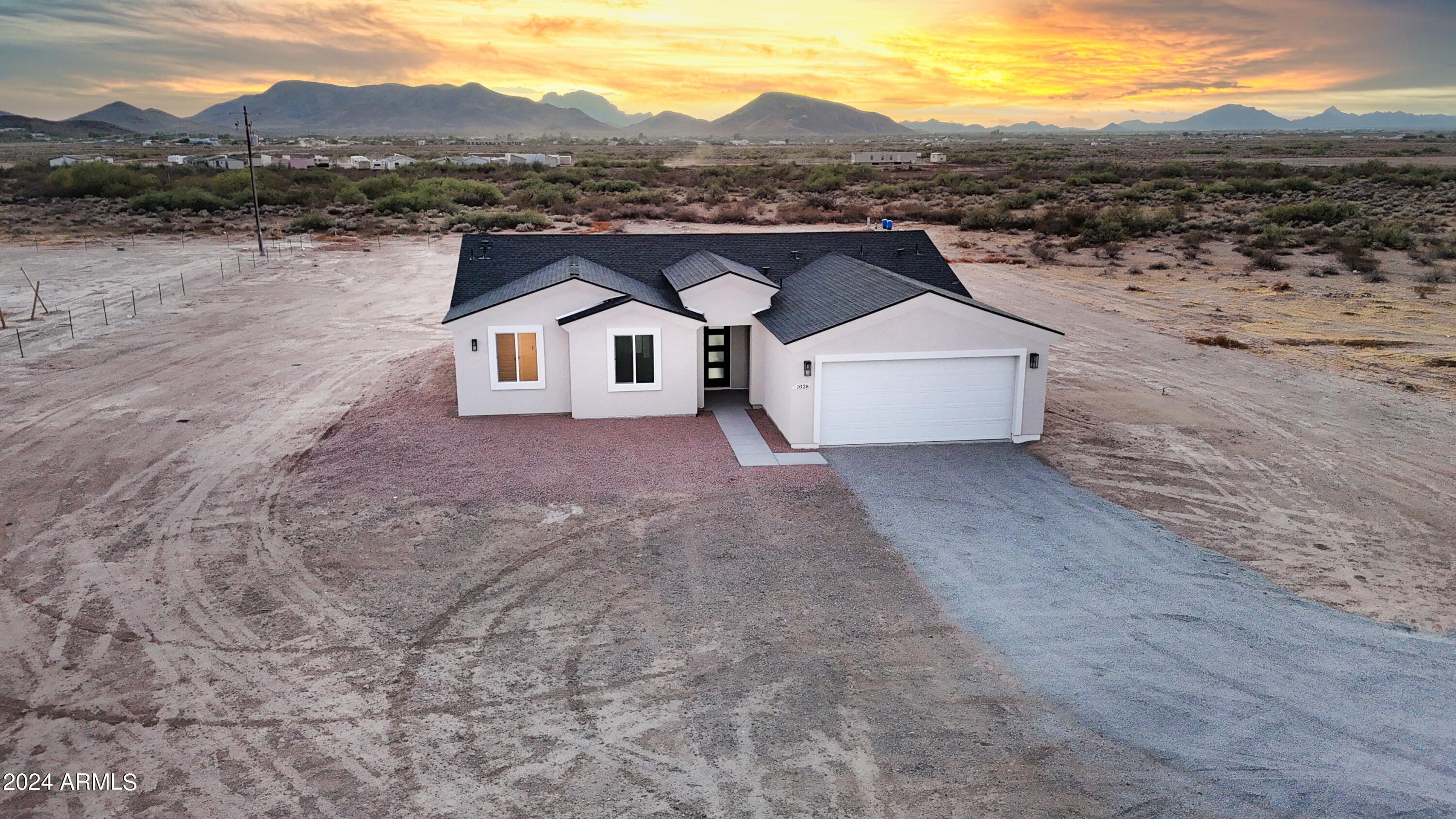 1028 South Wintersburg Road Tonopah, AZ 85354 - Photo 35 of 48 a front view of a house with a mountain