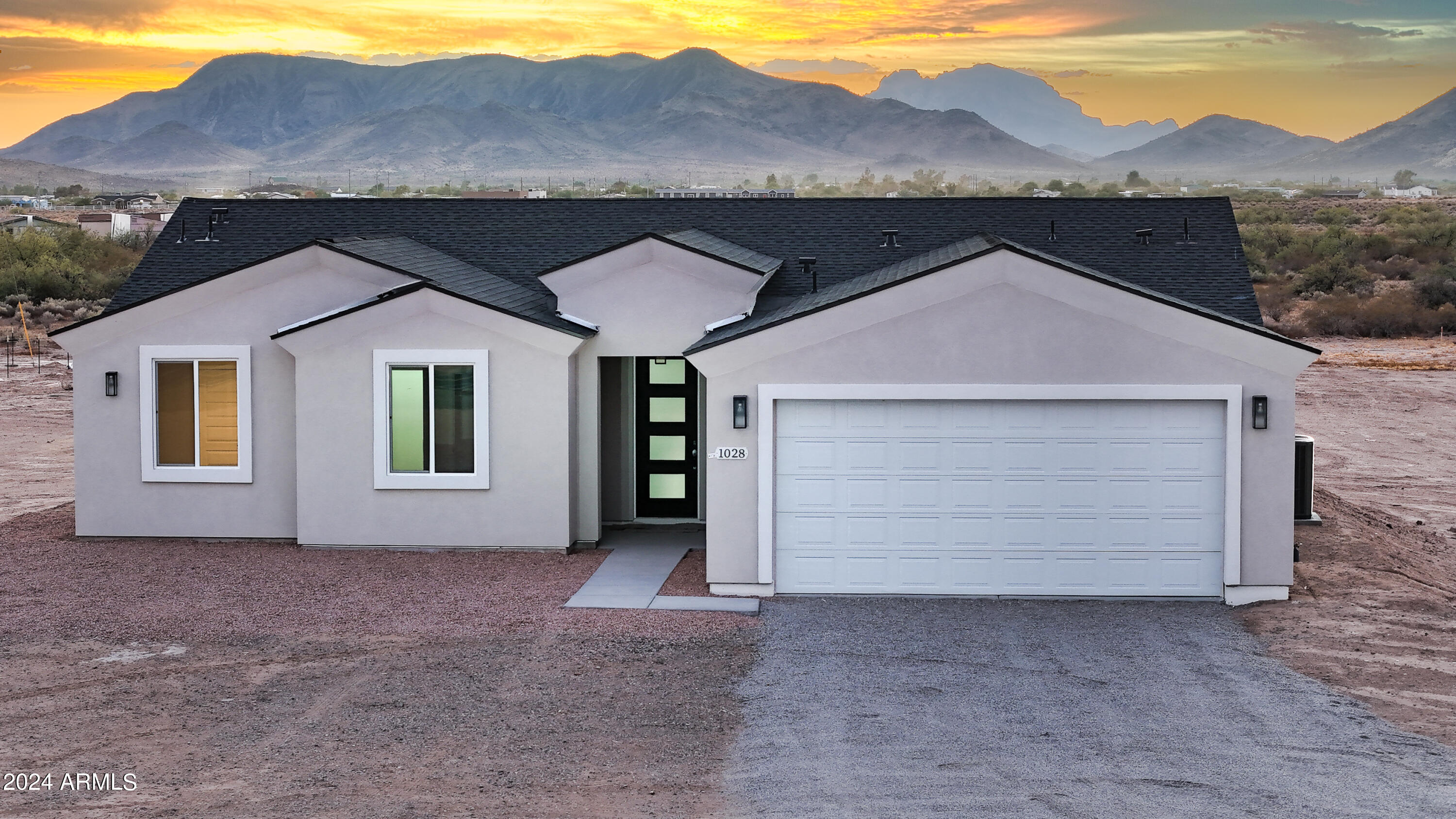 1028 South Wintersburg Road Tonopah, AZ 85354 - Photo 4 of 48 a front view of a house with a yard