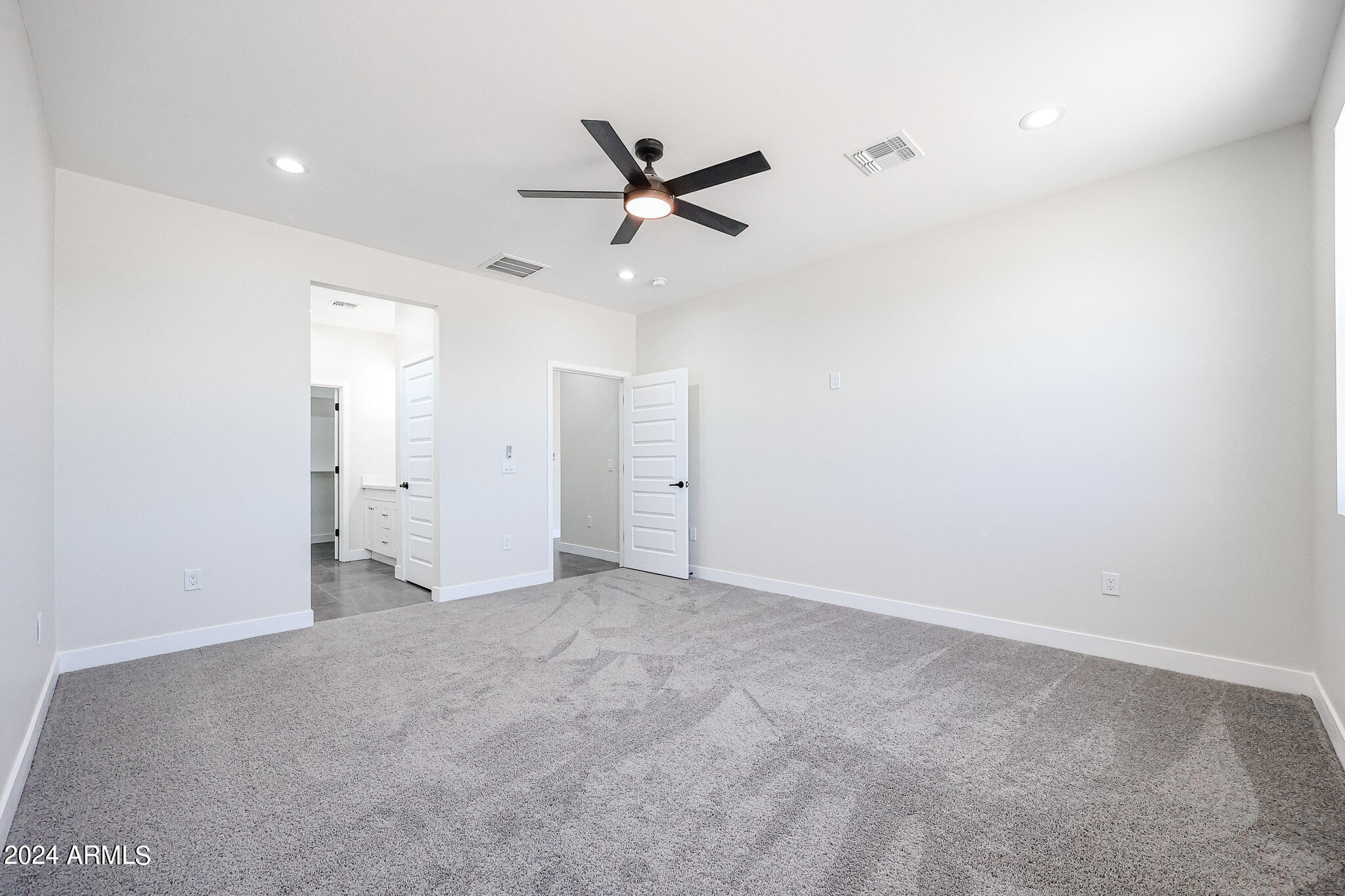 1028 South Wintersburg Road Tonopah, AZ 85354 - Photo 43 of 48 an empty room with closet and windows
