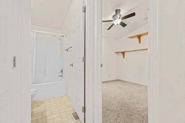 a view of room with a ceiling fan