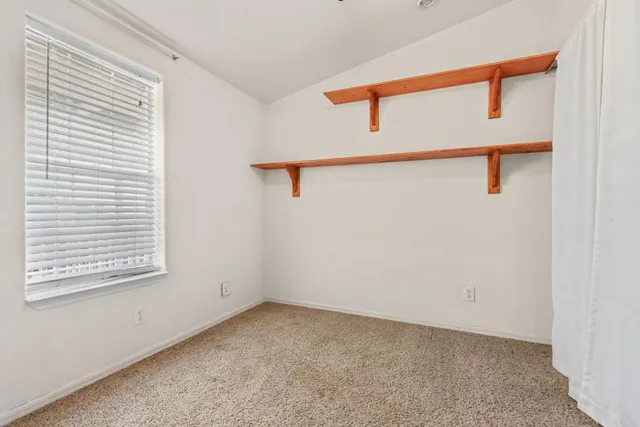 a furnished livingroom with a ceiling fan and window
