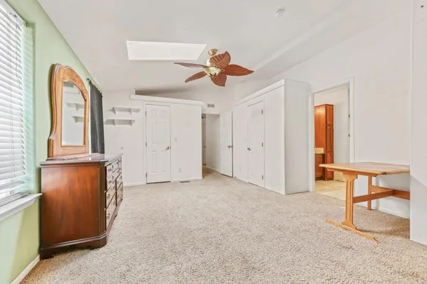 a bathroom with a granite countertop sink and a bathtub
