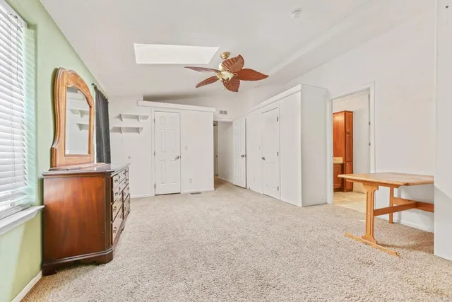 a bathroom with a granite countertop sink and a bathtub