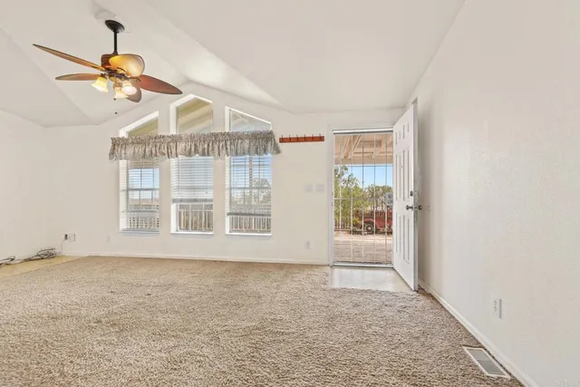 a view of a balcony with floor to ceiling windows with wooden floor