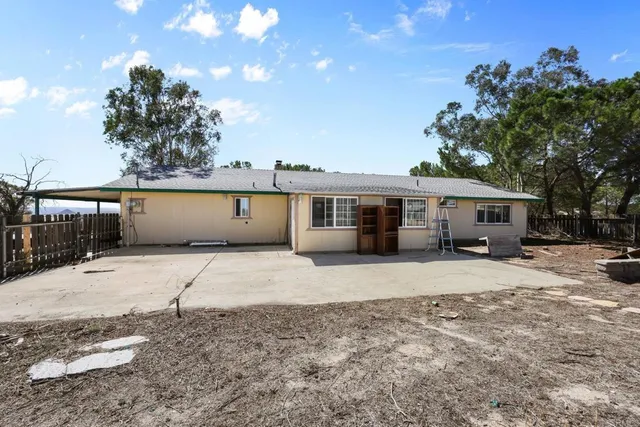 a kitchen with granite countertop a rug a stove a microwave and a counter top space