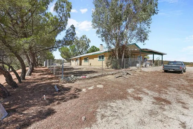 a kitchen with stainless steel appliances granite countertop a refrigerator a sink and a stove