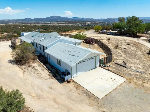 an aerial view of a house with a ocean view