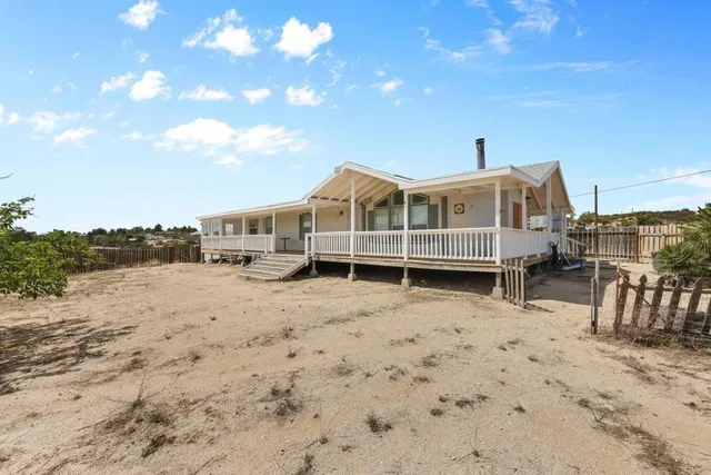 a view of a roof deck with wooden fence and floor