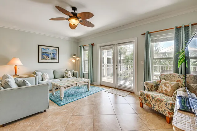 a living room with furniture and a large window with garden view