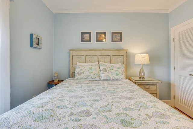 a bedroom with a bed and a lamp on table