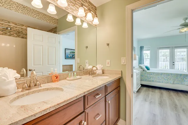 a bathroom with a granite countertop sink mirror and vanity