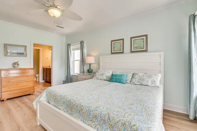a spacious bedroom with a large bed and a chandelier
