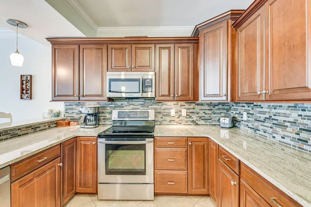 a kitchen with stainless steel appliances granite countertop a sink stove and microwave