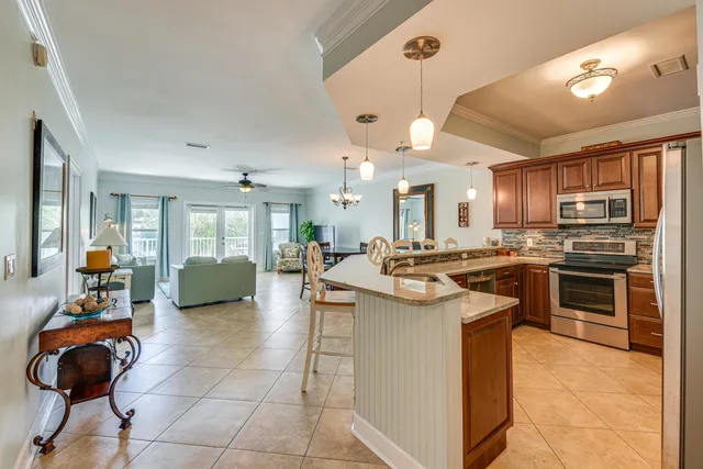 a kitchen with a sink a counter top space appliances and a view of kitchen