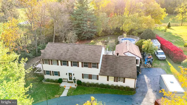 a aerial view of a house with a yard patio and fire pit