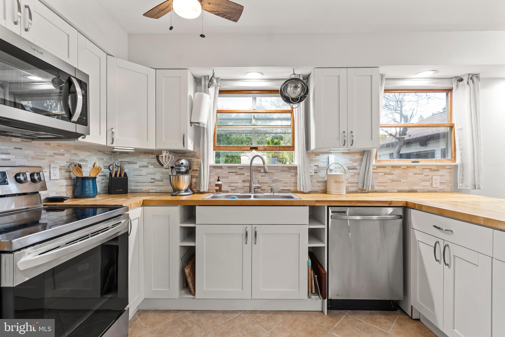 18347 Manor Church Road Boonsboro, MD 21713 - Photo 22 of 70 a kitchen with cabinets appliances and a window