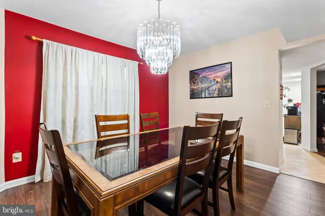 a kitchen with white cabinets and sink