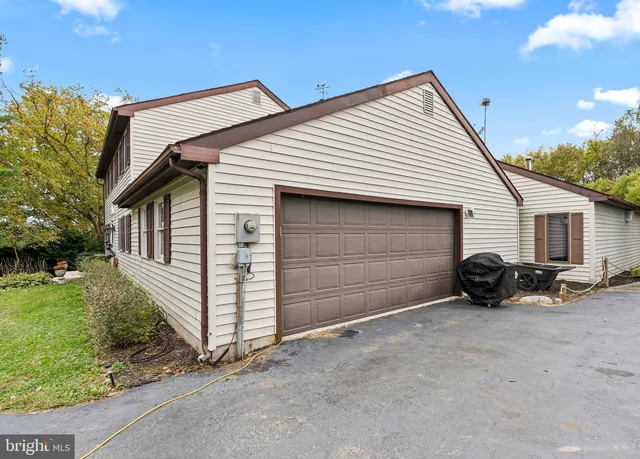 a kitchen with granite countertop a stove a sink dishwasher a refrigerator with a dining table and chairs