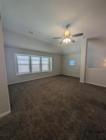 a view of a room with a ceiling fan