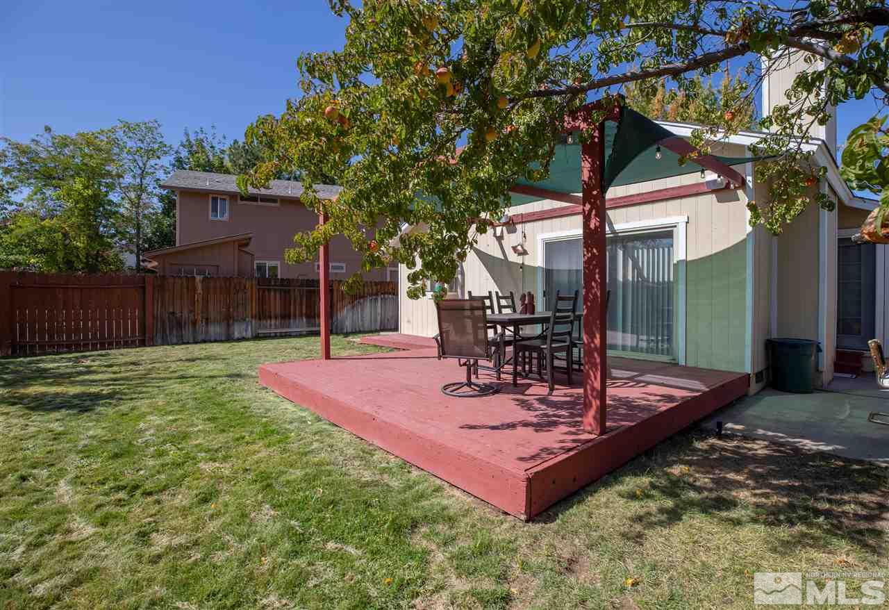 1114 Indian Cove Way Reno, NV 89523 - Photo 12 of 17 a view of a backyard with table and chairs and wooden fence