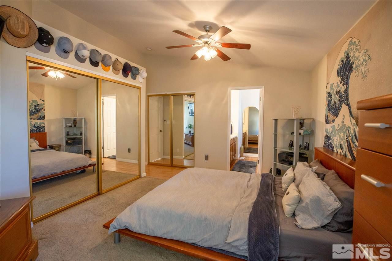 1114 Indian Cove Way Reno, NV 89523 - Photo 13 of 17 a bedroom with a bed and a chandelier