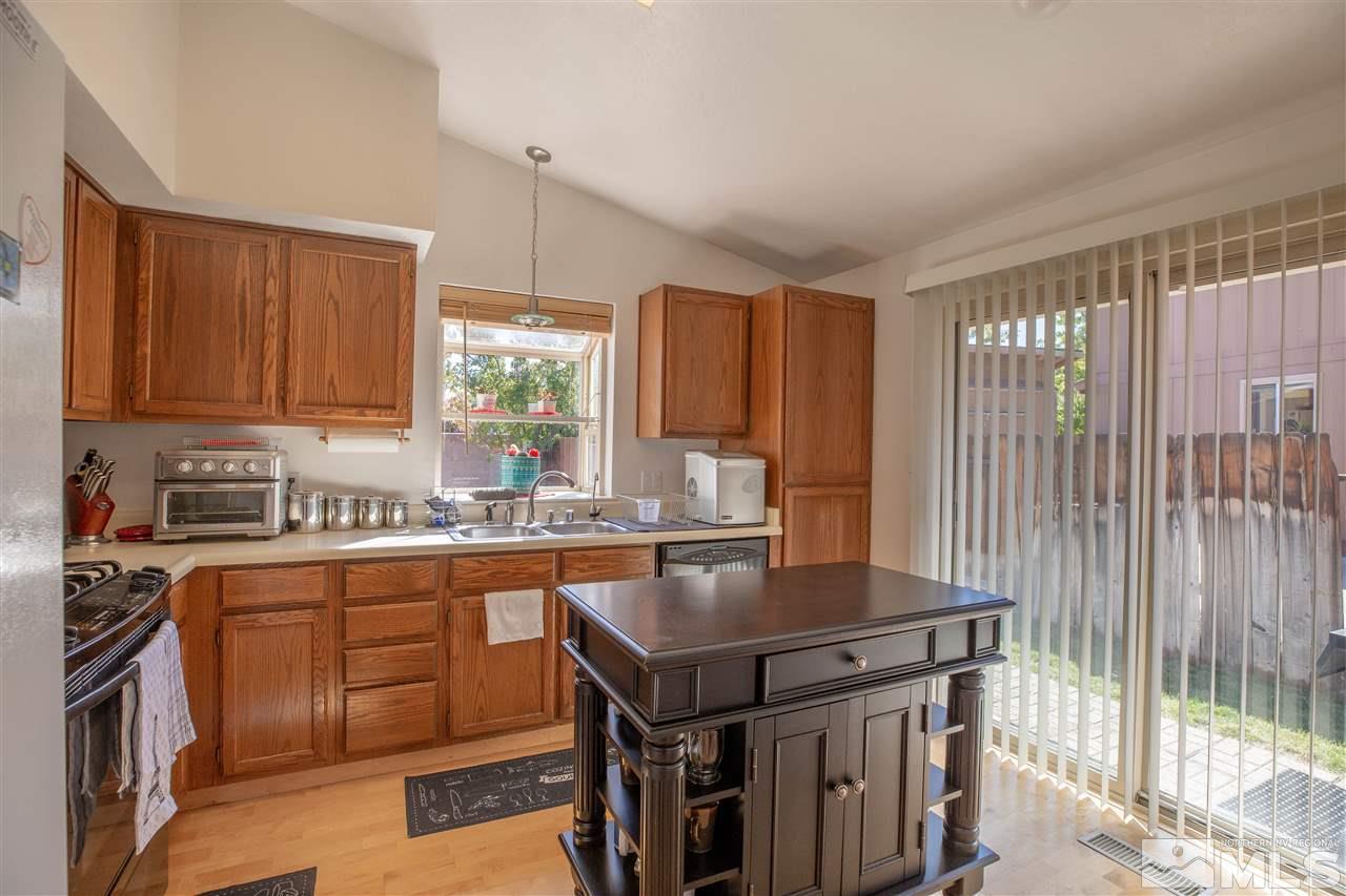1114 Indian Cove Way Reno, NV 89523 - Photo 9 of 17 a kitchen with a stove a sink and a microwave