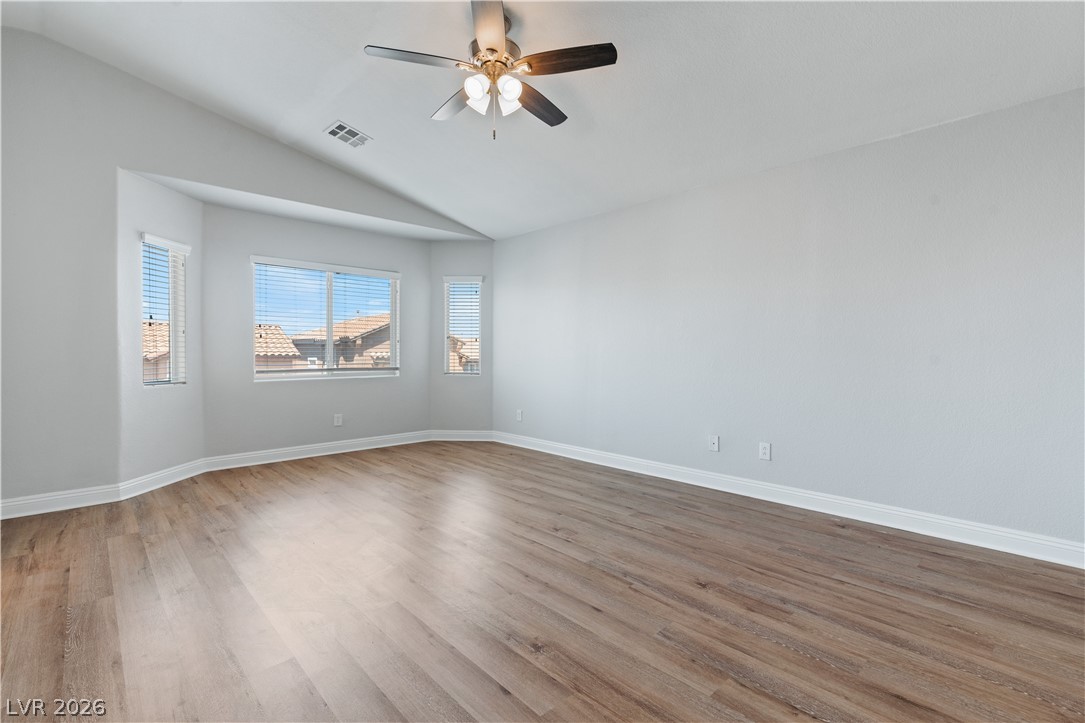 1328 Spice Ridge Court Henderson, NV 89012 - Photo 21 of 51 This spacious Primary bedroom offers ample natural light and beautiful hardwood flooring.