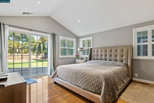 a bedroom with a large bed and a window