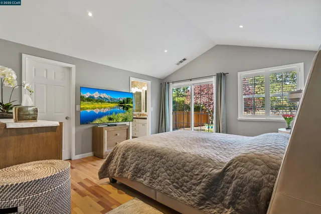 a bedroom with a bed and a flat screen television