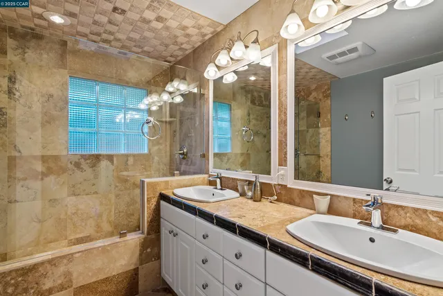 a bathroom with a double vanity sink mirror and double