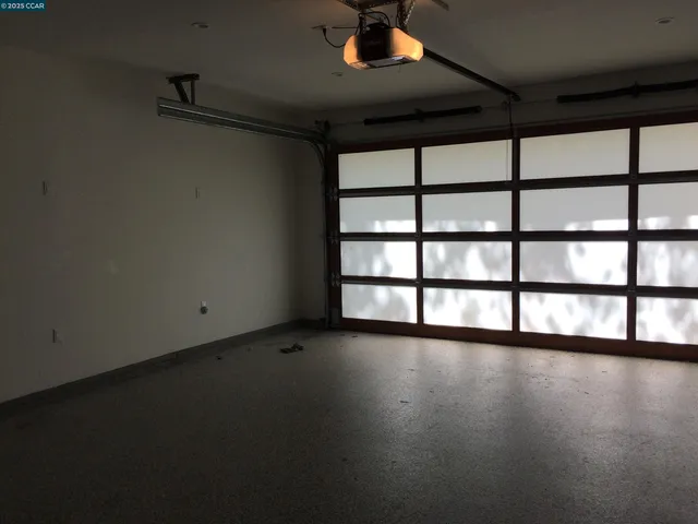 a view of room with window and wooden floor