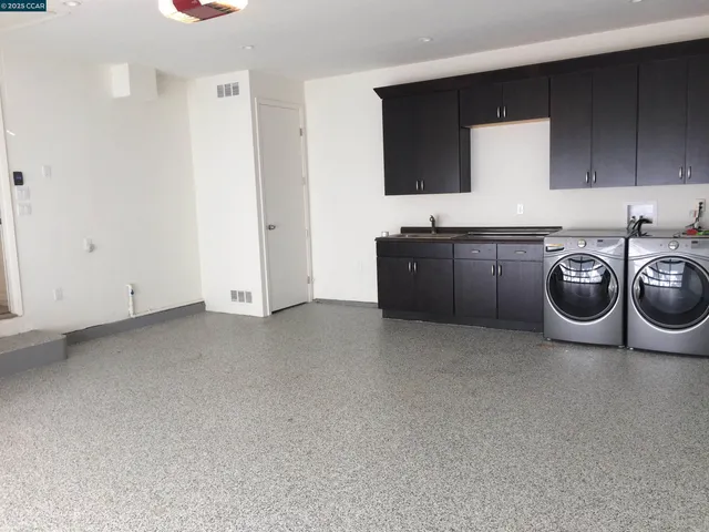 a kitchen with a sink a stove and cabinets