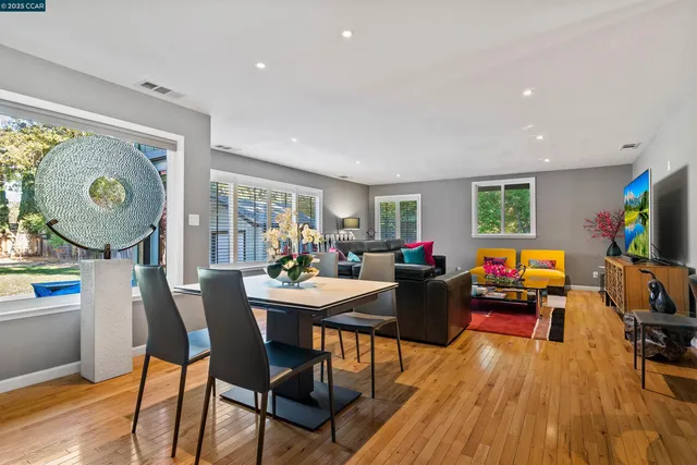 a view of a dining room with furniture and wooden floor