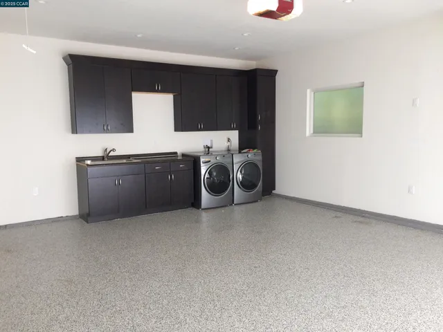 a kitchen with a sink and a stove top oven
